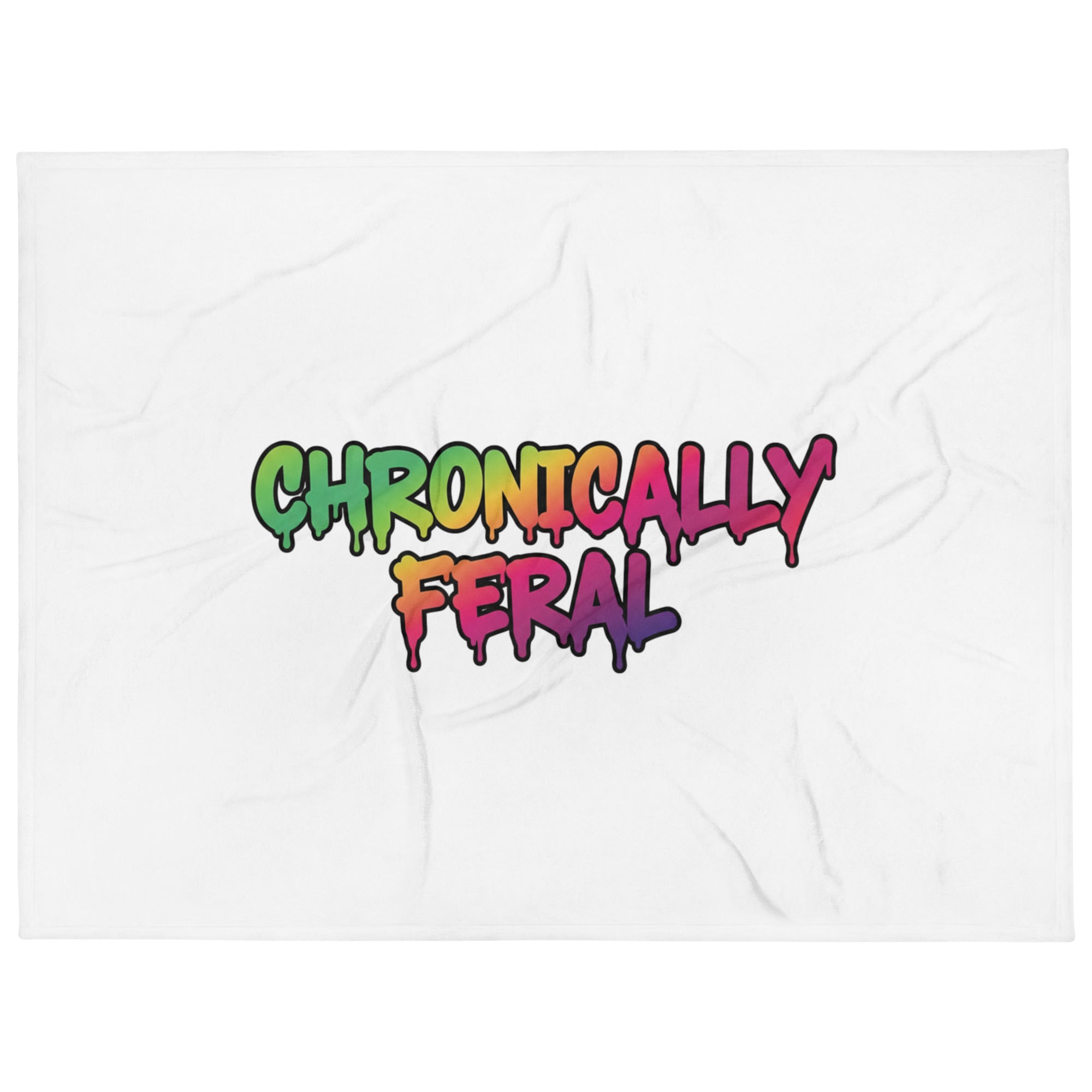 White throw blanket with "CHRONICALLY FERAL" in two-line centered graffiti lettering with a full rainbow gradient — green through purple — with soft paint drips. Feral as Fhawk™.